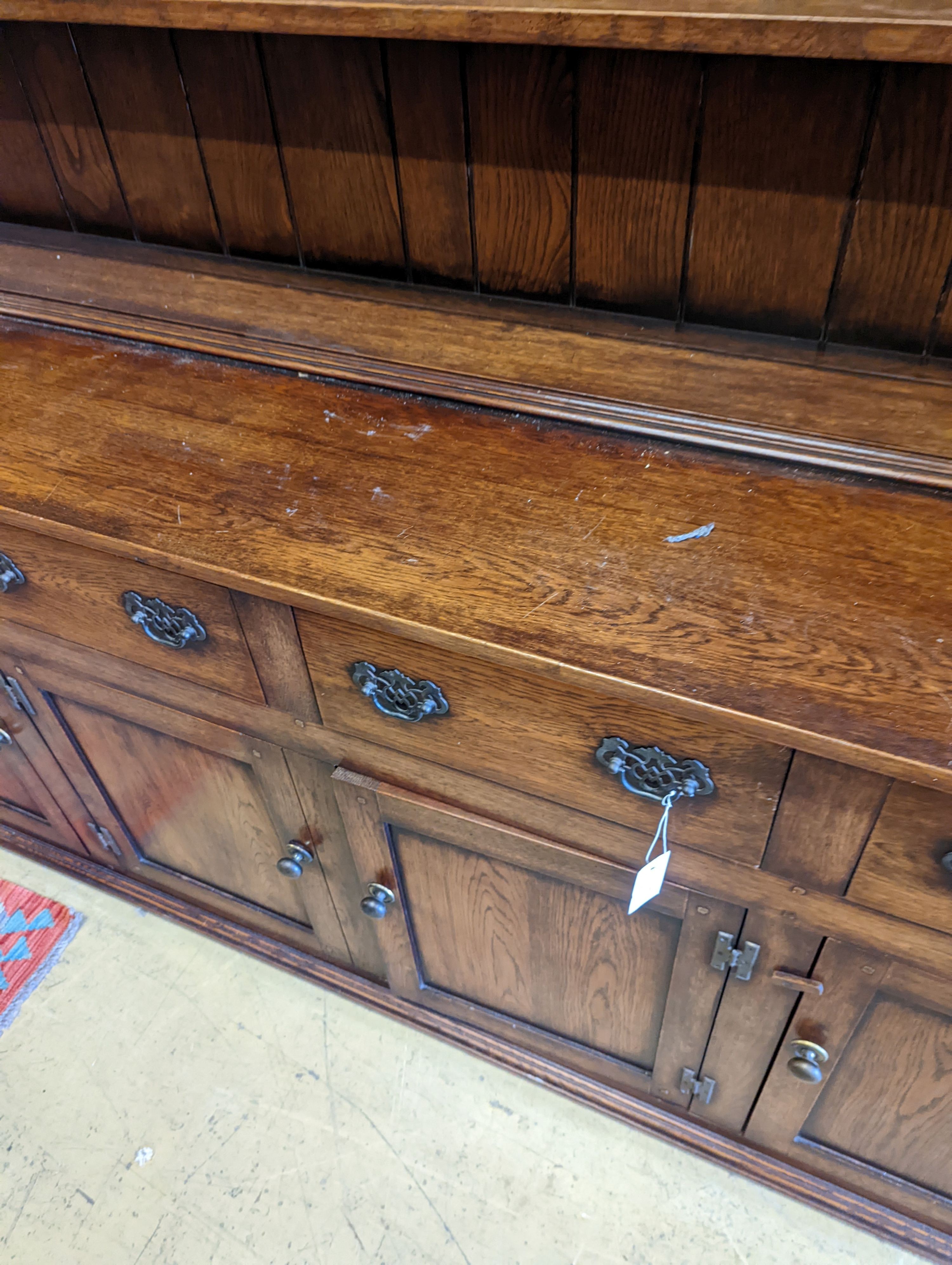 An 18th century style oak dresser with boarded plate rack, width 199cm, depth 48cm, height 198cm